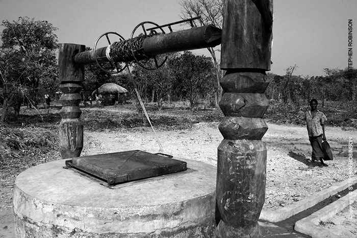 026_CZmA.8341BW-African-Village-Woman-&-Carved-Water-Well-NW-Zambia