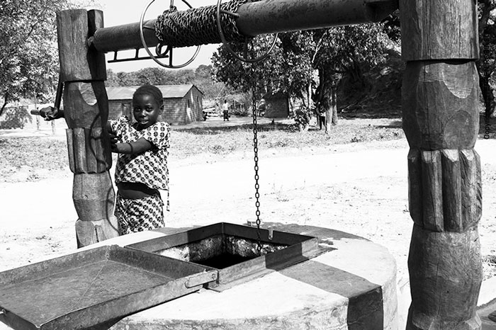 027_CZmA.8548BW-African-Village-Girl-&-Carved-Water-Well-NW-Zambia