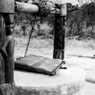 029_CZmA.8796BW-African-Carved-Water-Well-&-Village-Woman-NW-Zambia